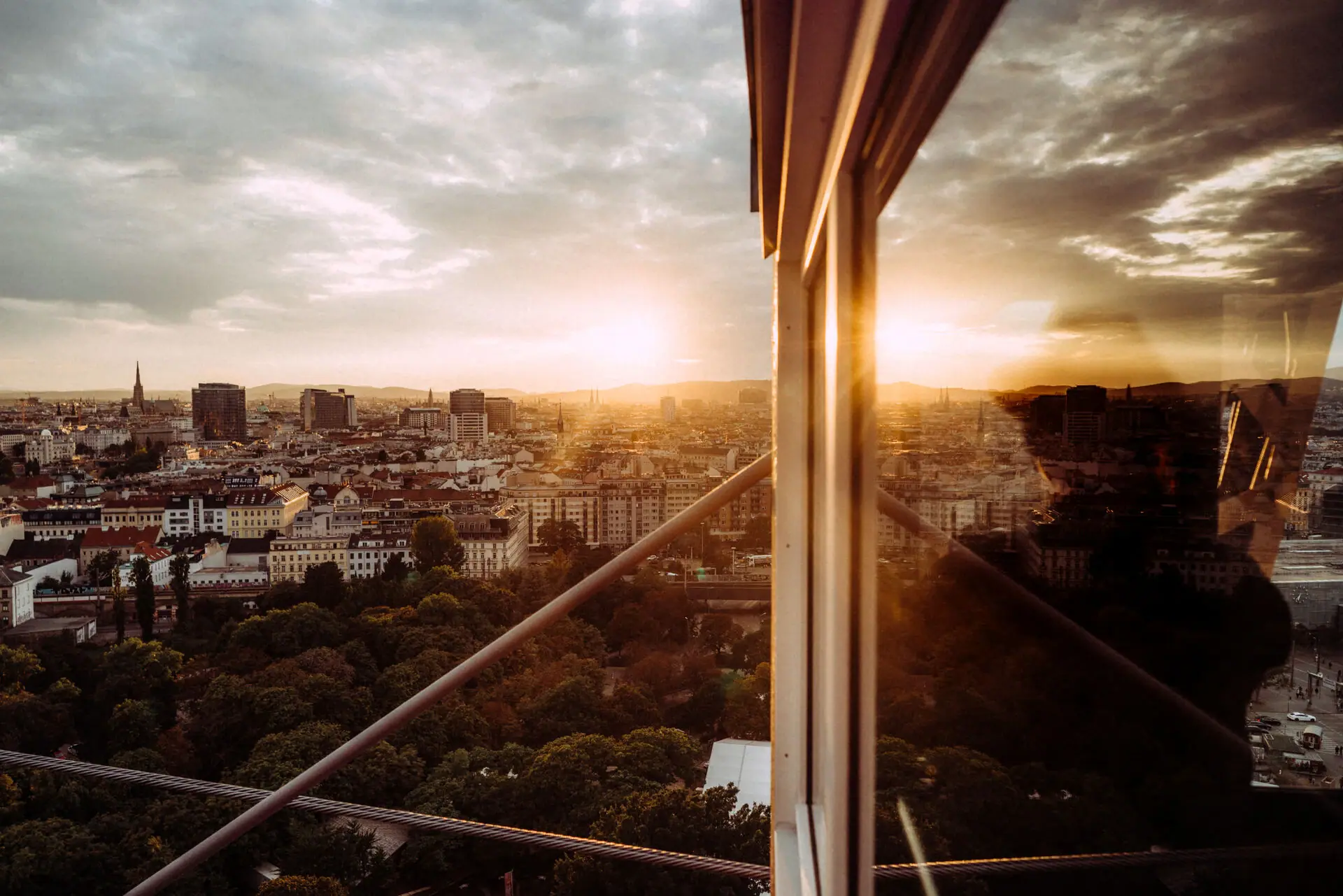 Blick auf eine Stadt durch ein Fenster mit Wolken und Himmel im Hintergrund.