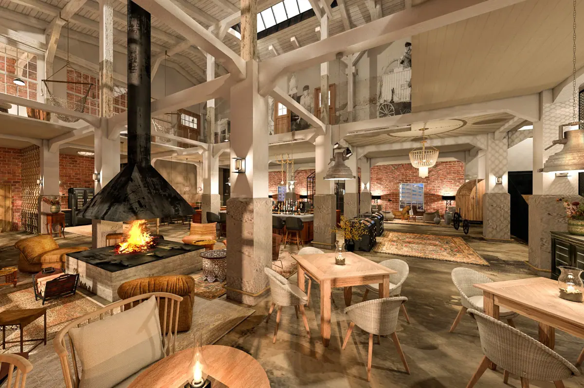 Ein offener Raum mit hohen Decken, einigen Tischen, Stühlen, Sesseln und einem Kamin.