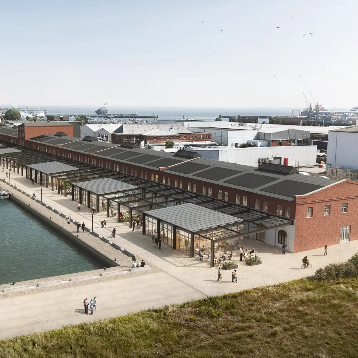 Ein Dock mit einer Reihe von Gebäuden und einem Gewässer.