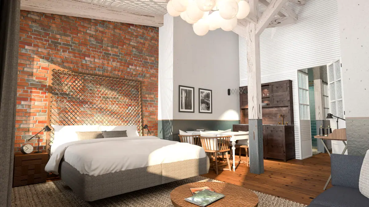 Innenansicht eines Hotelzimmers im HENRI Hotel Cuxhaven mit einem Bett, Tisch und Stühlen.